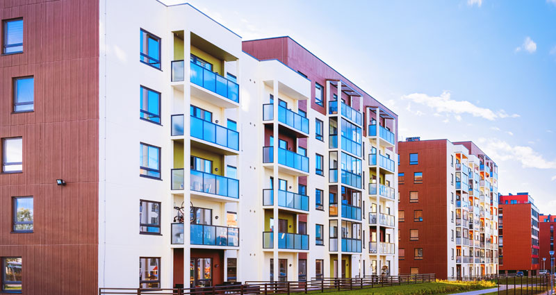 apartment buildings green house in hand