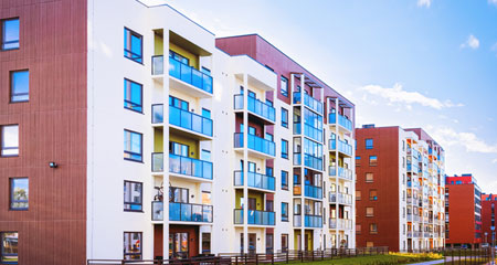 apartment buildings green house in hand