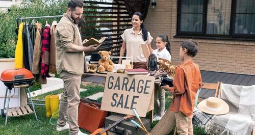 Family selling at garage sale to customer