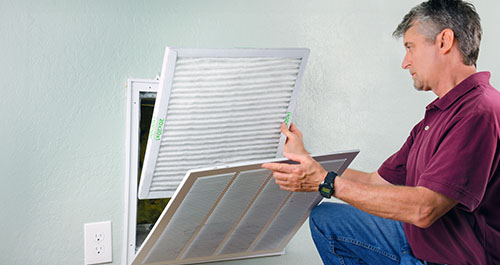 Man changing AC filter(