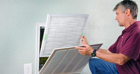 Man changing AC filter(