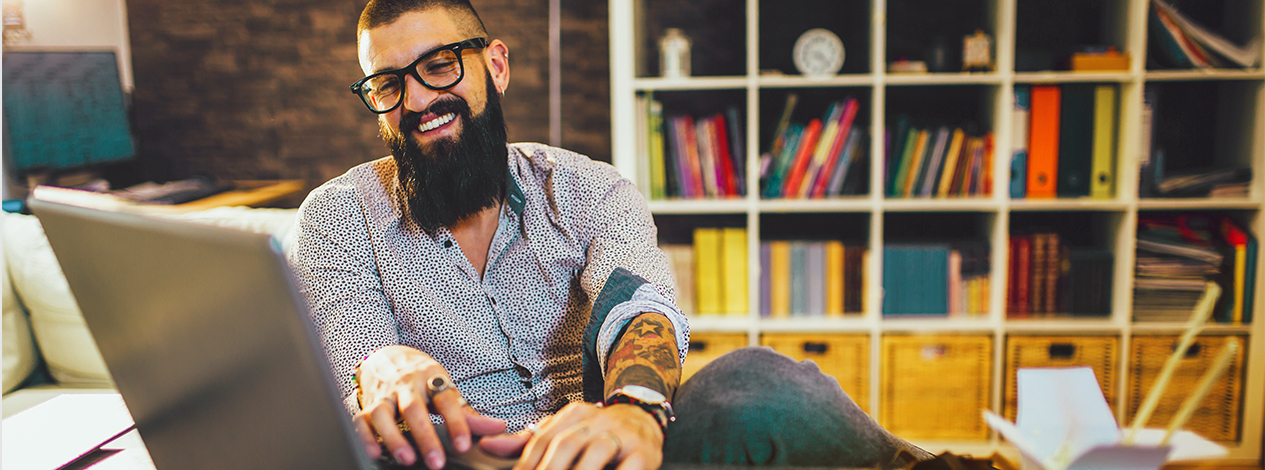 man-working-on-laptop-smiling