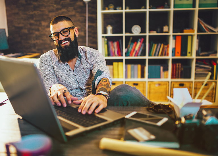 man-working-on-laptop-smiling