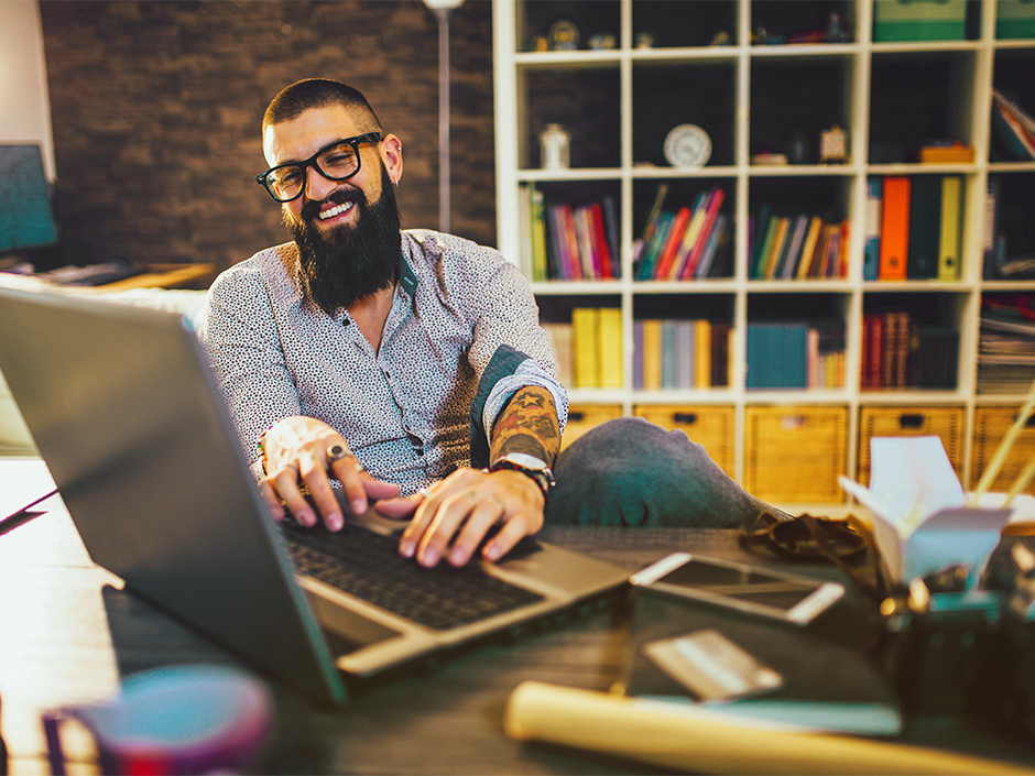 man-working-on-laptop-smiling