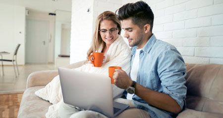 Couple on a laptop while enjoying coffee