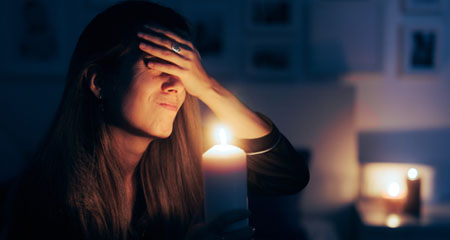 Woman holding candle in the dark