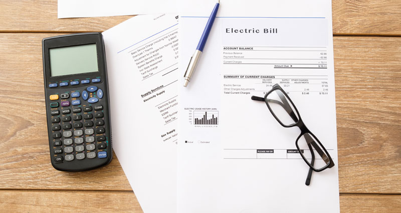 Electric bill and calculator on table