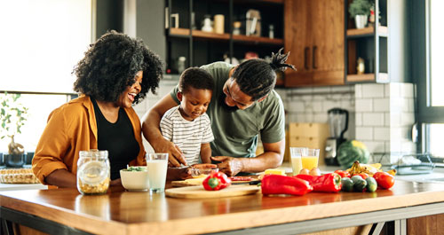 Parents and kid cooking in the kitchen